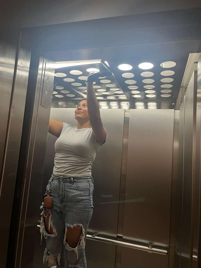 Crew member detailing an elevator interior